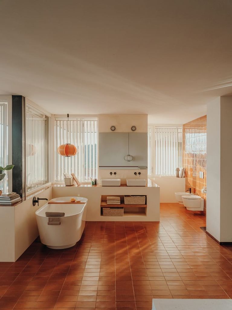 Tura bathroom with a freestanding bath, twin basins and slatted blinds