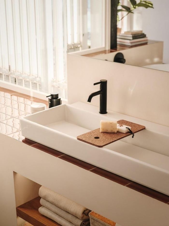 Tura basin with a black tap and a cork tray