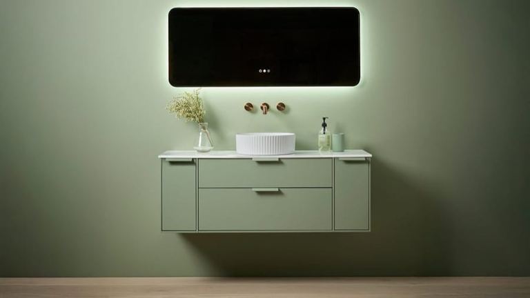 Faber 1000 unit in Matt Sage Green under a backlit rectangular mirror