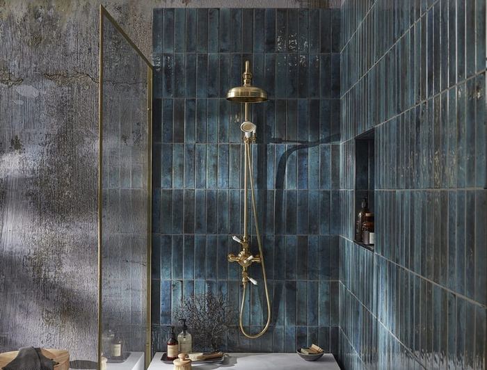 Keswick exposed shower system in brushed brass on blue tiles