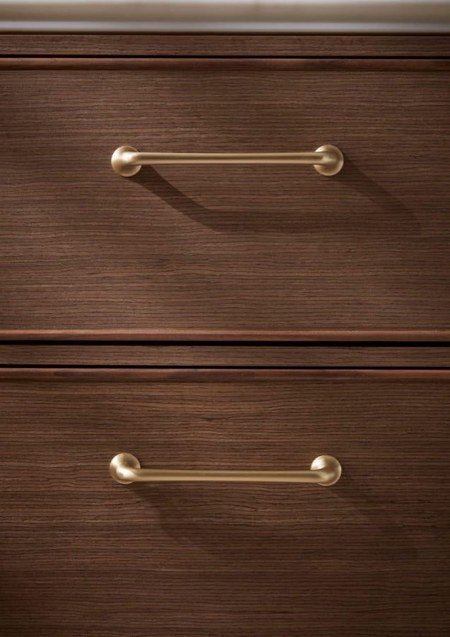 Walcot brass pull handles on a Walnut drawer front