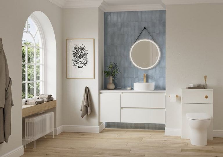 Hartley vanity in Powder White below an arched window with blue tiling